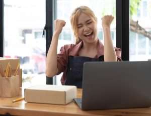 a happy young girl is celebrating her new small business website created by ck web design dublin - articles featured image by ck web design